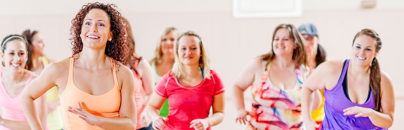 A group of females at an indoor exercise class.